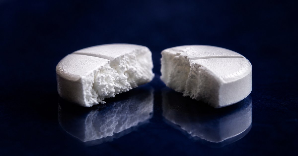 Comprimé et molécule stylisée évoquant une dose infinitésimale de traitement
